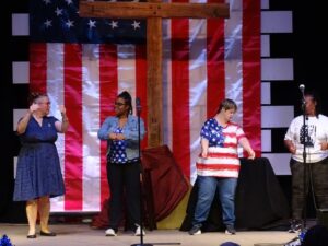 Four women dancing at the Aspire Living & Learning talent show.
