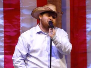 Man singing at the Aspire Living & Learning talent show