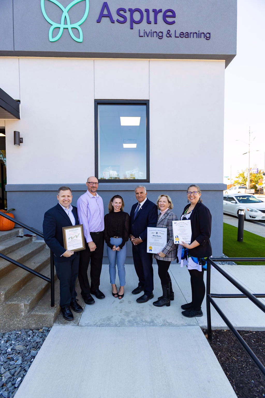 Local officals presenting proclaimations to leaders from Aspire Living & Learning 