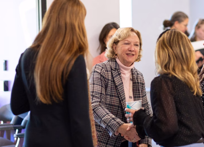 Aspire Living & Learning CEO Erica Hare greets Beth Walsh.
